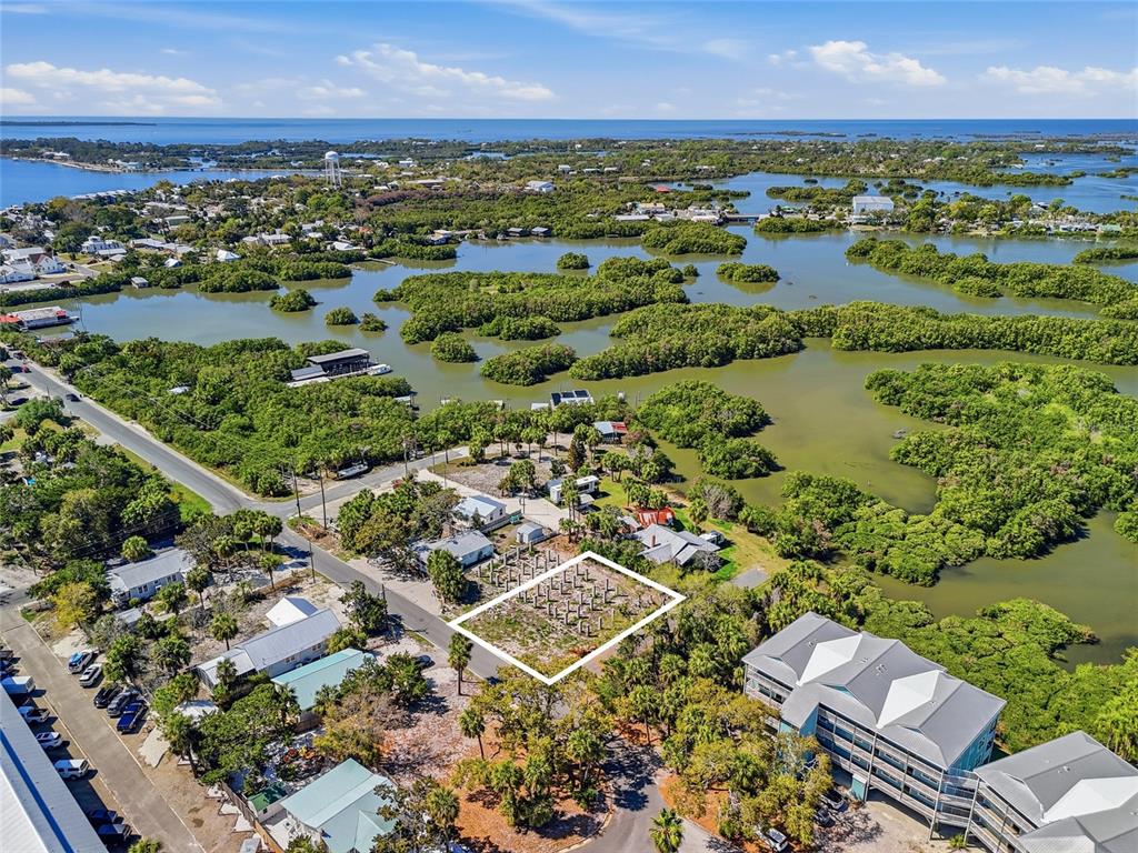 An aerial view shows a vacant rectangular lot outlined in white within a coastal neighborhood — TBD 3RD STREET, CEDAR KEY, FL