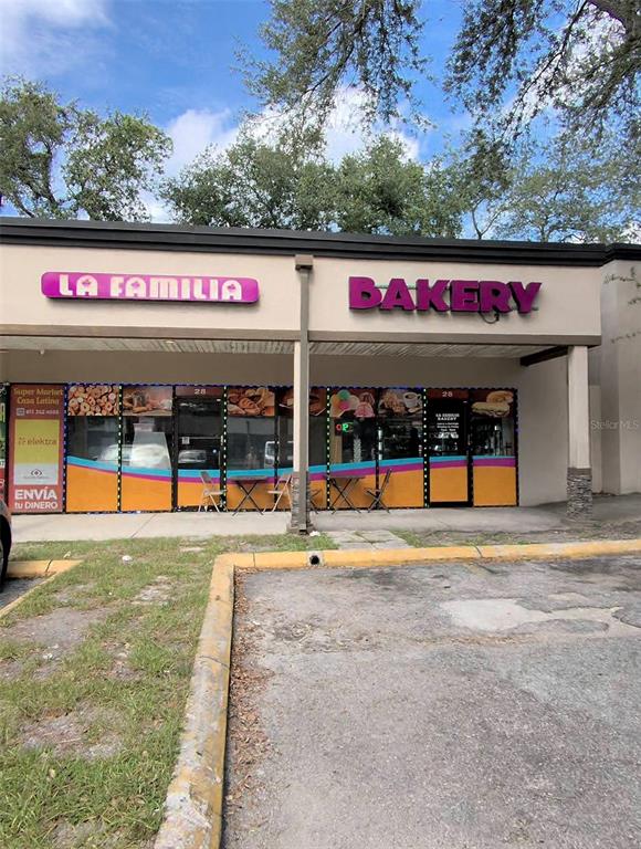 The exterior of a commercial building features a storefront with signage for La Familia Bakery — 1450 SKIPPER ROAD, TAMPA, FL