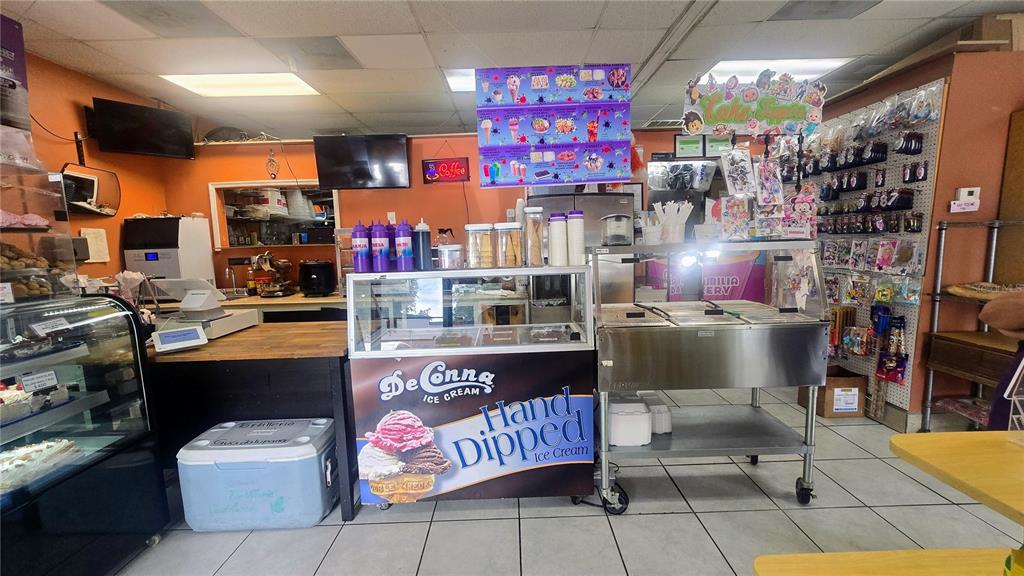 This interior view shows an ice cream and bakery shop counter with display cases — 1450 SKIPPER ROAD, TAMPA, FL