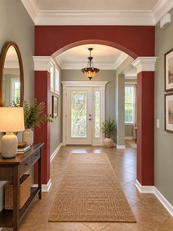 A black dresser sits against a wall with two square windows and a hanging lamp — 2379 PICKFORD CIRCLE, APOPKA, FL