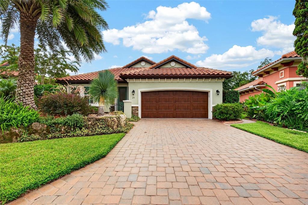A single-story house with a brown garage door, tile roof, and a paved driveway — 29 APIAN WAY, ORMOND BEACH, FL