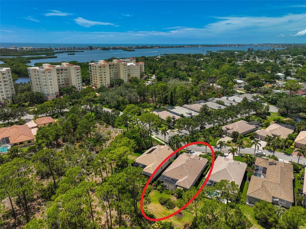 An aerial view shows a residential house with a screened-in patio and a fenced backyard — 293 TURQUOISE LANE, OSPREY, FL