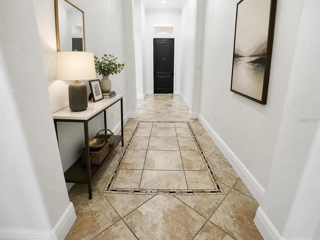 An entryway features a dark brown door, white walls, and light-colored diagonal tile flooring — 1404 CARING COURT, MAITLAND, FL