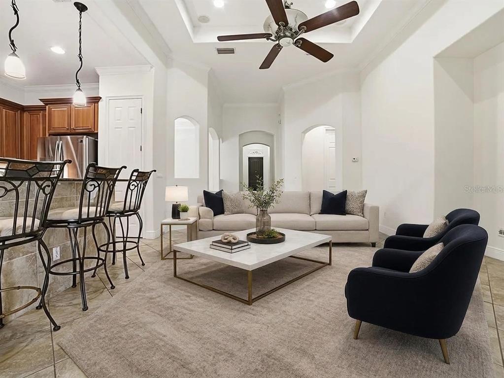 A kitchen features wood cabinets, stainless steel appliances, granite countertops, and diagonal tile flooring — 1404 CARING COURT, MAITLAND, FL