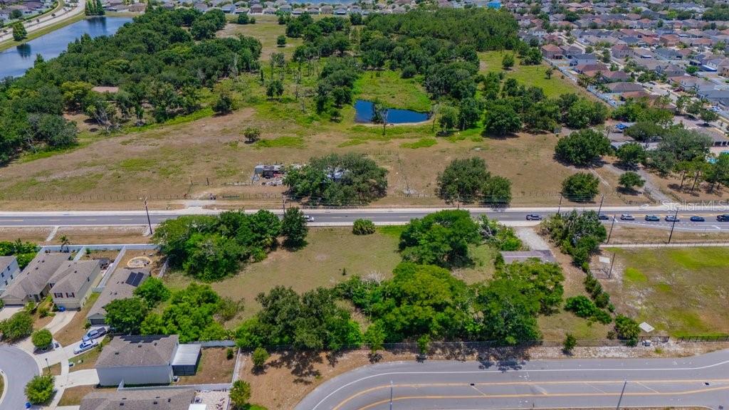 An aerial view shows a large, undeveloped plot of land situated between two paved roads — 10912 672 HIGHWAY, RIVERVIEW, FL