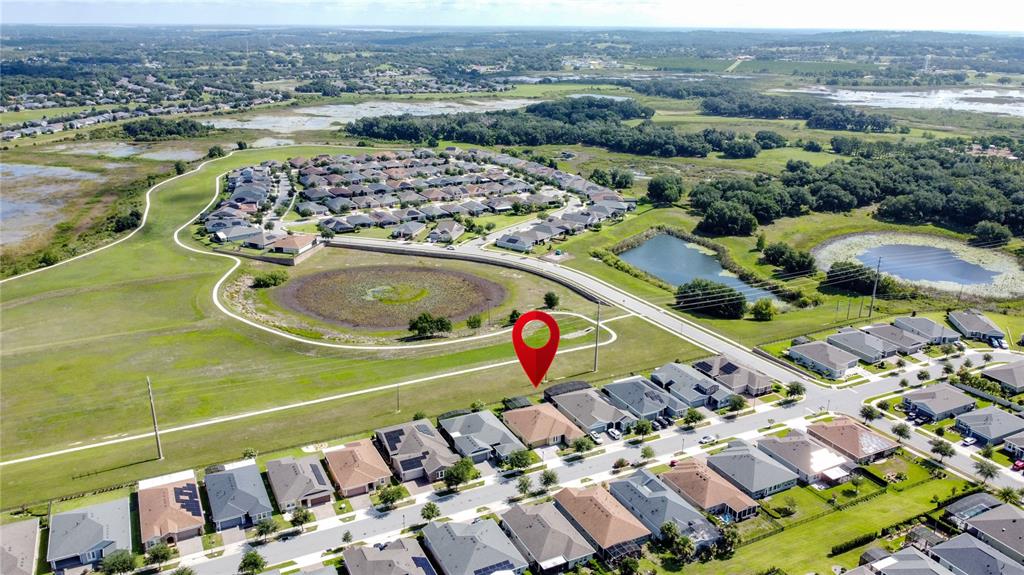An aerial view shows a residential neighborhood with a red location pin over a house — 164 SILVER MAPLE ROAD, GROVELAND, FL