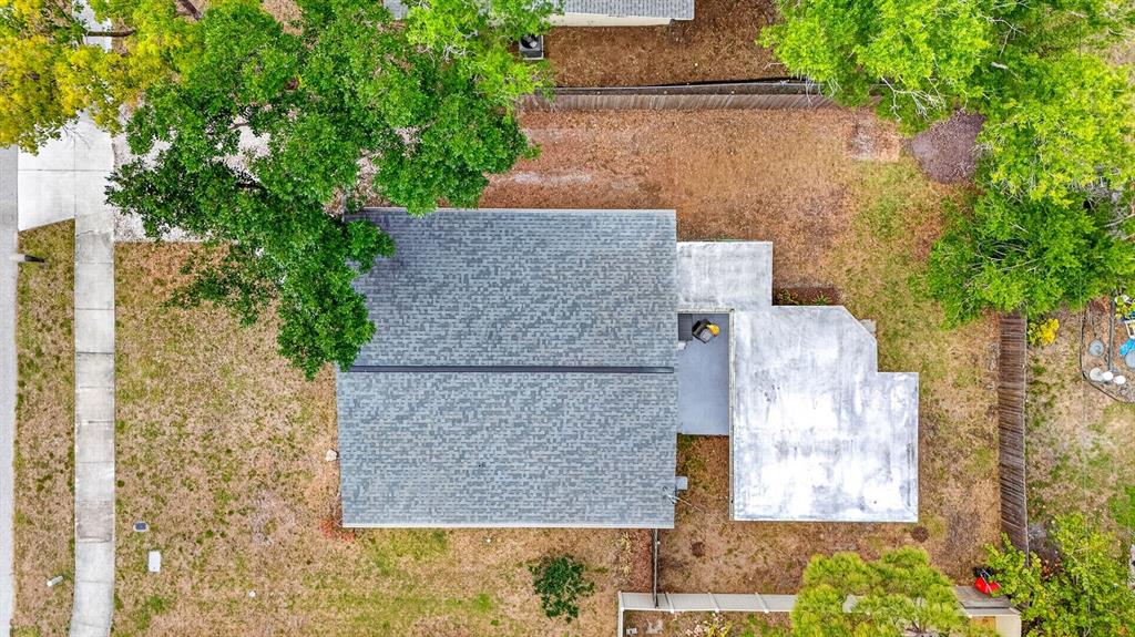 A screened-in porch with a concrete floor, a grill, and a white fence in the background — 916 PATTISON AVENUE, SARASOTA, FL