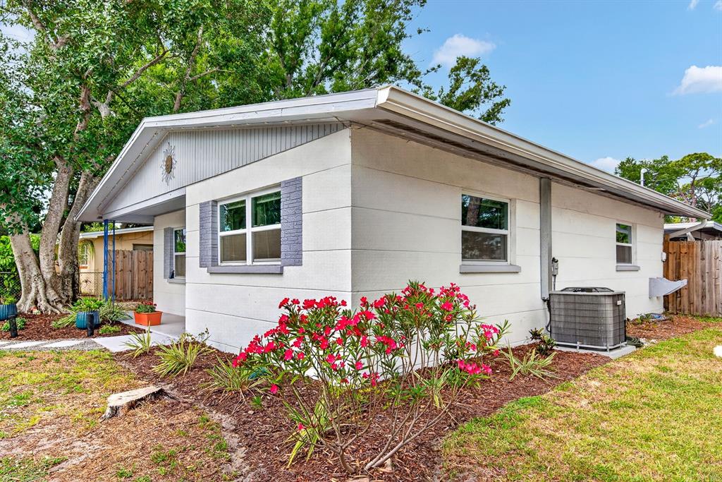 A covered patio features a concrete floor, wicker furniture, a grill, and a utility closet — 916 PATTISON AVENUE, SARASOTA, FL