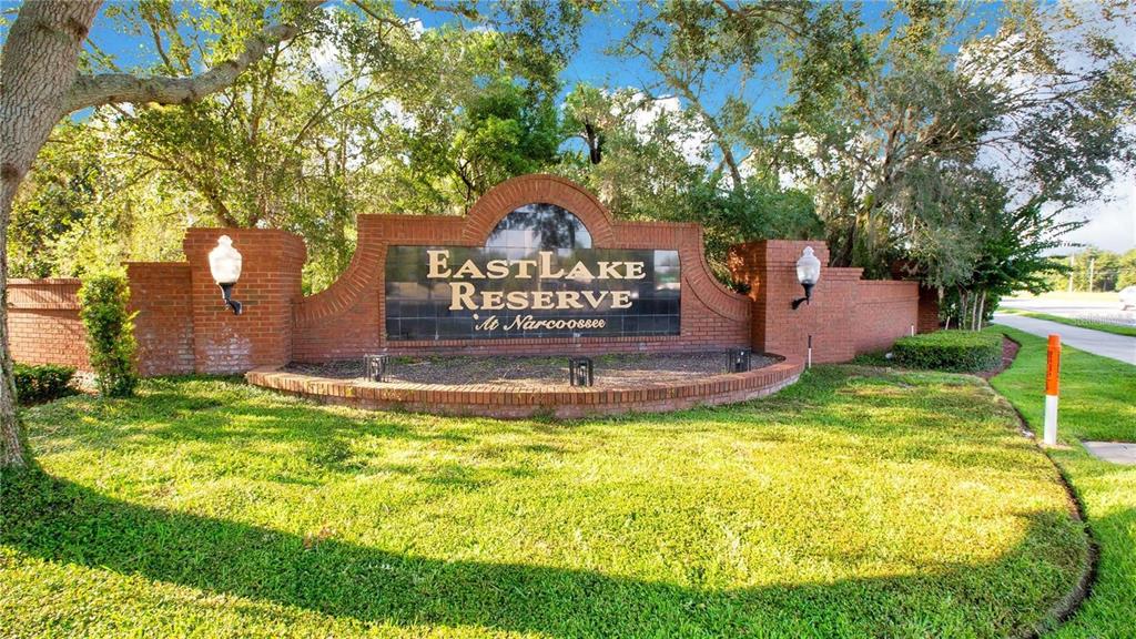 A brick entrance sign for EastLake Reserve at Narcoossee stands in a grassy area — 4810 CALASANS AVENUE, ST CLOUD, FL