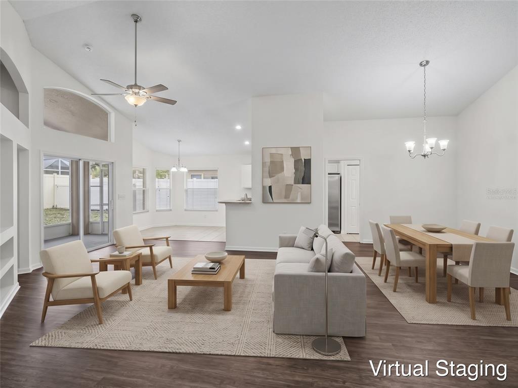 An empty bedroom features white walls, dark wood-look flooring, a ceiling fan, and arched windows — 15854 BAY VISTA DRIVE, CLERMONT, FL