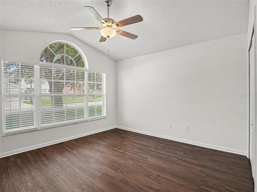 A dining area with tile flooring, a chandelier, and windows with white blinds — 15854 BAY VISTA DRIVE, CLERMONT, FL