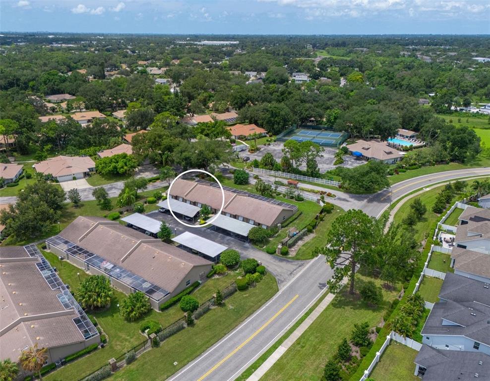 An aerial view shows a residential complex with a circled unit and covered parking — 5506 37TH STREET E UNIT 4, BRADENTON, FL
