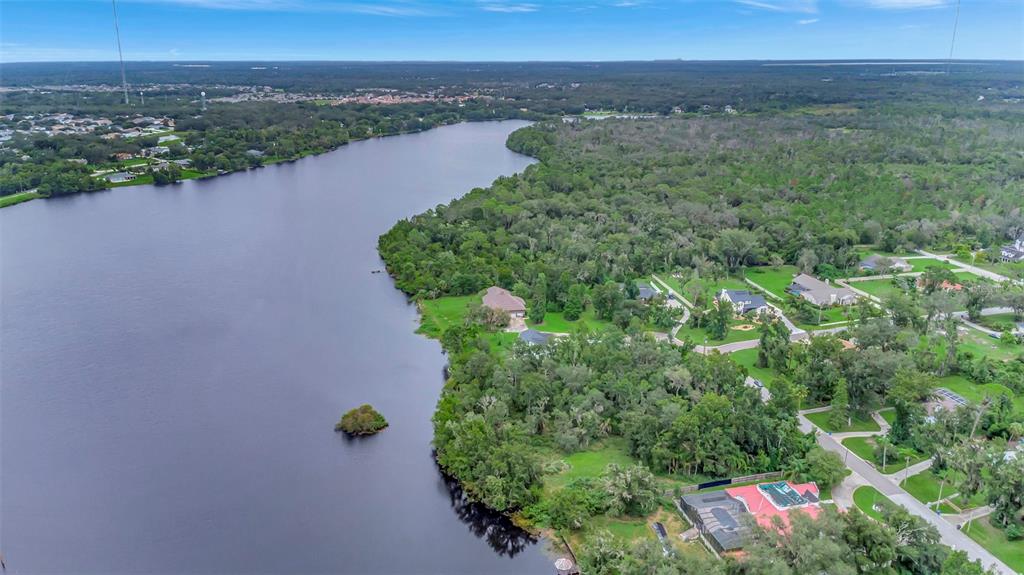 An aerial view of a lake surrounded by dense trees and residential homes — 12612 LAKE HILLS DRIVE, RIVERVIEW, FL