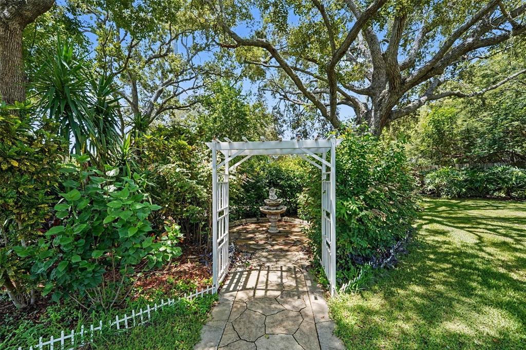 A screened-in patio features a swimming pool with a raised spa and paver decking — 3061 ALT 19, PALM HARBOR, FL