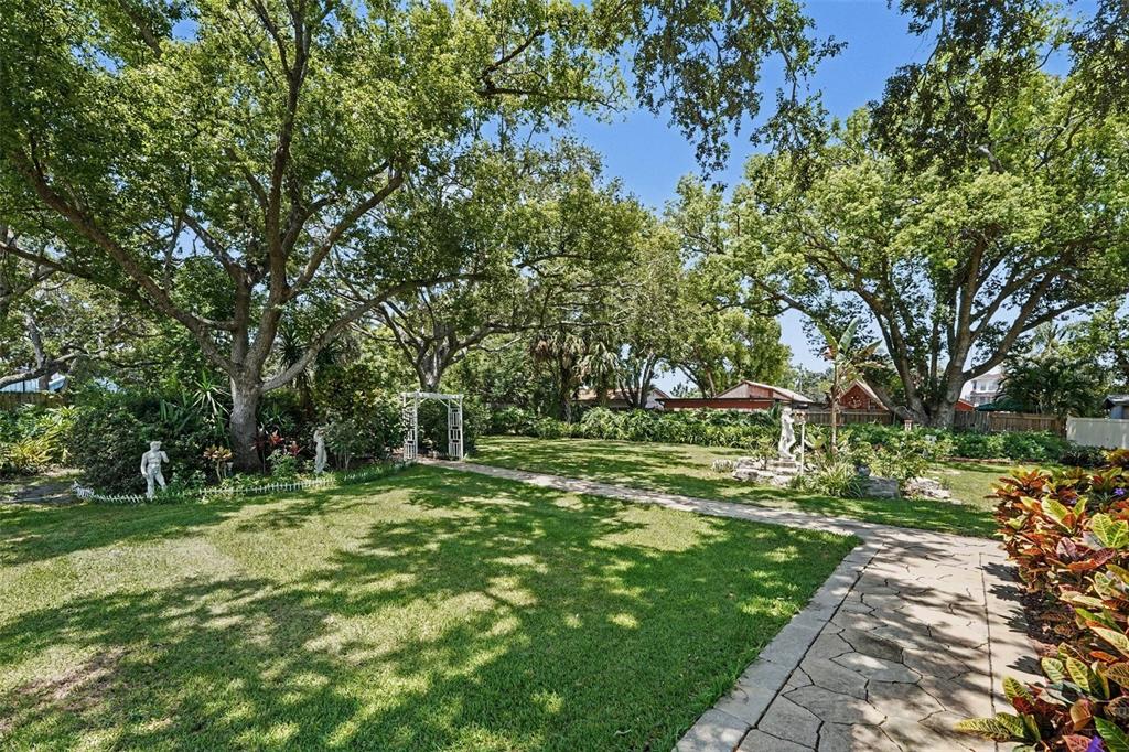 A kitchen with light wood cabinets, stainless steel appliances, and a view of a pool — 3061 ALT 19, PALM HARBOR, FL