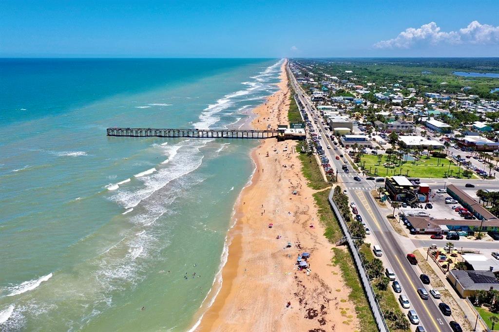 An aerial view shows a row of colorful waterfront houses with private boat docks — 2727 MORNING LIGHT COURT, FLAGLER BEACH, FL