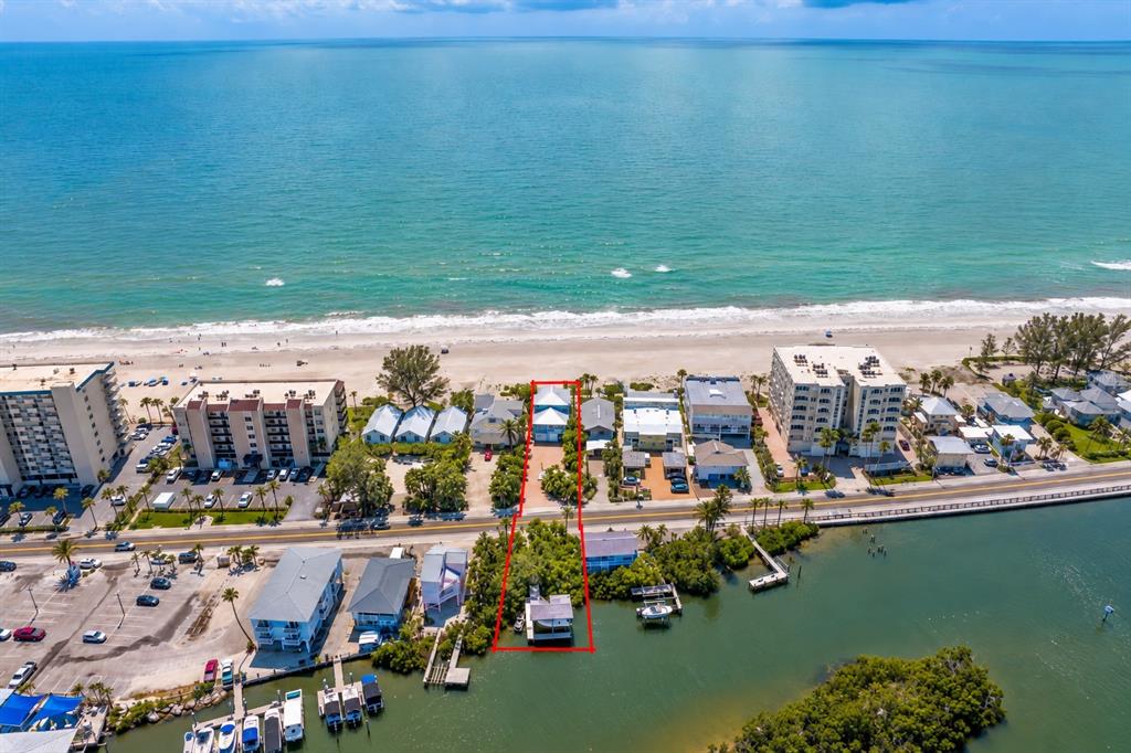 A view of three beach houses from the sandy shore on a sunny day — 20060 GULF BOULEVARD, INDIAN SHORES, FL