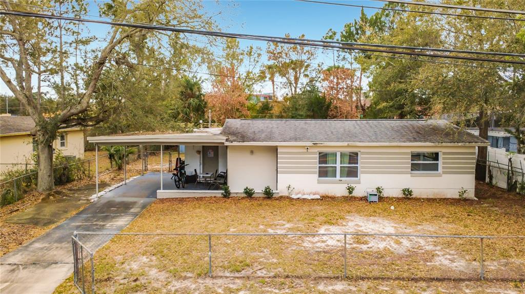 A single-story house with a carport, light-colored siding, and a fenced front yard — 741 HILLVIEW DRIVE, ALTAMONTE SPRINGS, FL