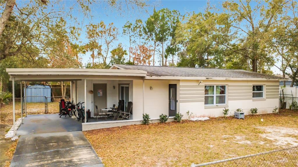 A single-story house with a carport, light-colored siding, and a front yard with trees — 741 HILLVIEW DRIVE, ALTAMONTE SPRINGS, FL