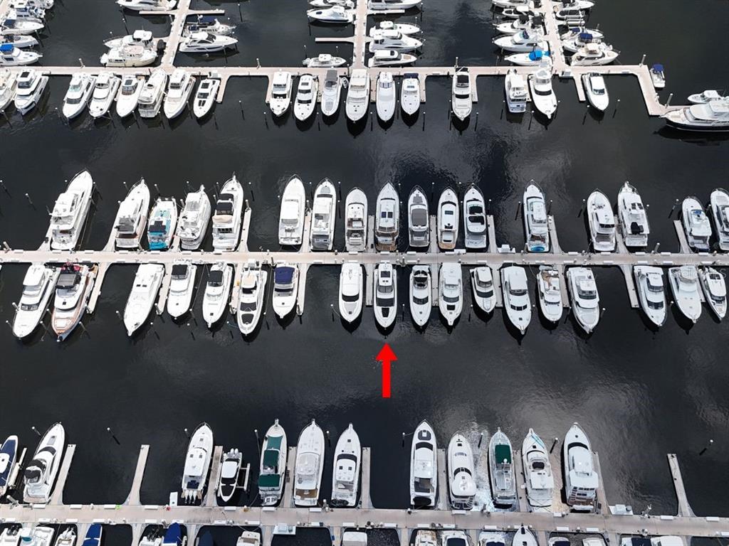An aerial view shows numerous boats docked in slips at a marina — 102 RIVIERA DUNES WAY UNIT C-12, PALMETTO, FL