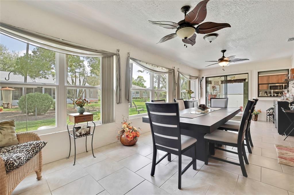 An aerial view of a single-story house with a brown roof, dormers, and a garage — 6433 LOST TREE LANE, SPRING HILL, FL