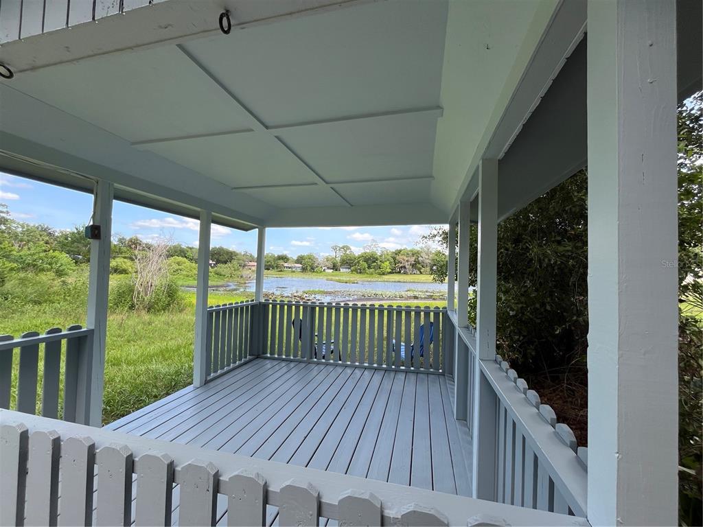 A single-story gray house with a shingled roof sits on a grassy lot with trees — 119 MATANZAS ROAD, DEBARY, FL