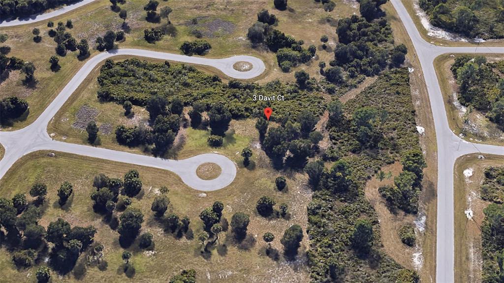 An aerial view shows a vacant, wooded residential lot located at the end of a cul-de-sac — 3 DAVIT COURT, PLACIDA, FL