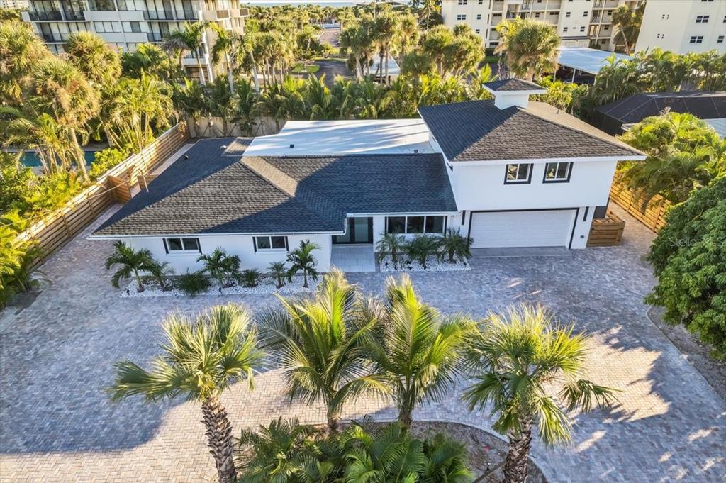 An aerial view of a white house with a dark roof and a paved driveway — 5624 CAPE LEYTE DRIVE, SARASOTA, FL