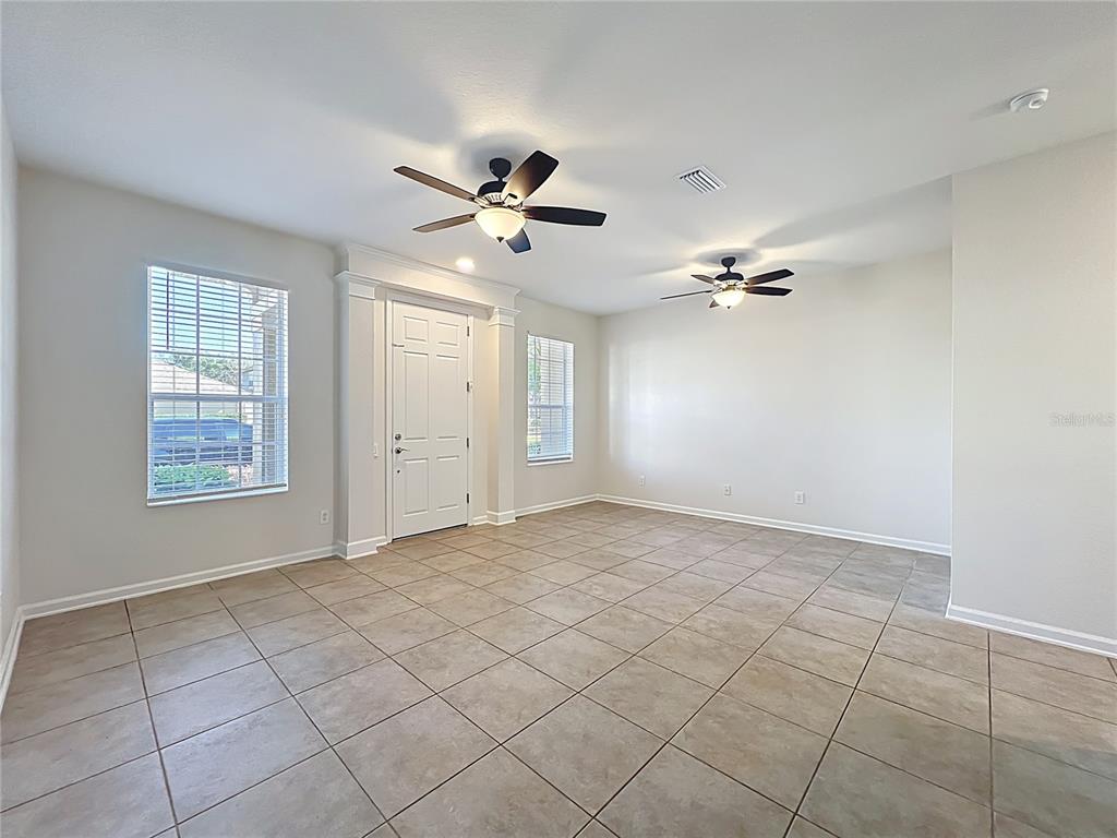 A kitchen with wood cabinets, a granite island, and glass doors leading to a patio — 12930 VENNETTA WAY, WINDERMERE, FL