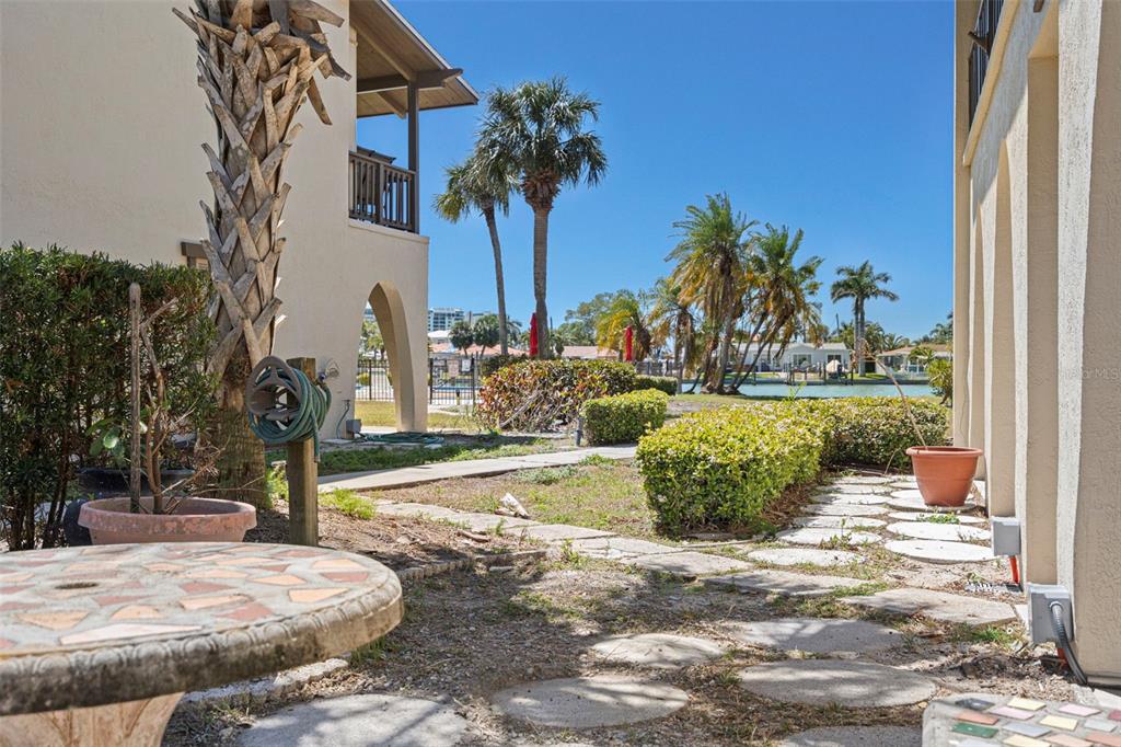 A dining area with tiled floors, a chandelier, and a partial wall opening to the kitchen — 505 PLAZA SEVILLE COURT UNIT 11, TREASURE ISLAND, FL