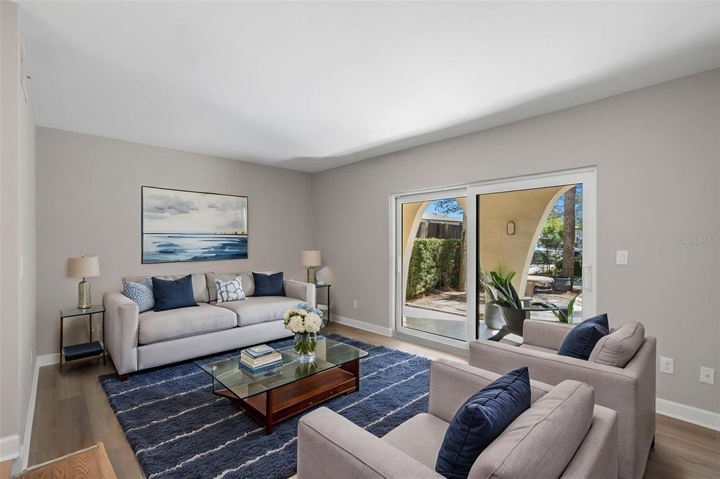 A kitchen features white cabinets, marble-patterned countertops, stainless steel appliances, and a corner sink — 505 PLAZA SEVILLE COURT UNIT 11, TREASURE ISLAND, FL