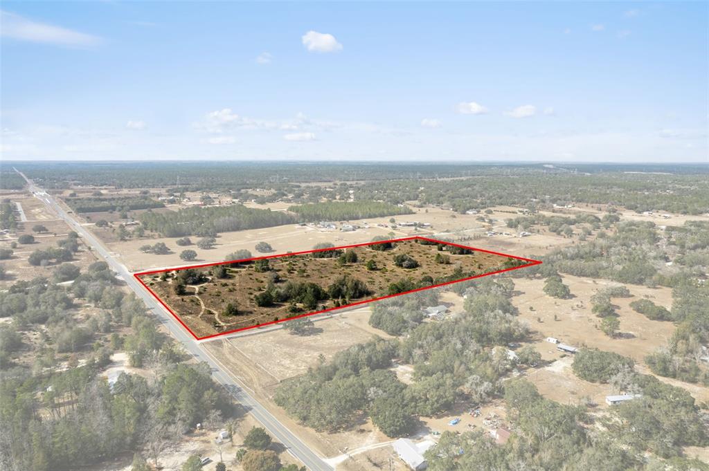 An aerial view shows a rectangular plot of land outlined in red along a road — 6725 S RAINBOW POINT, HOMOSASSA, FL