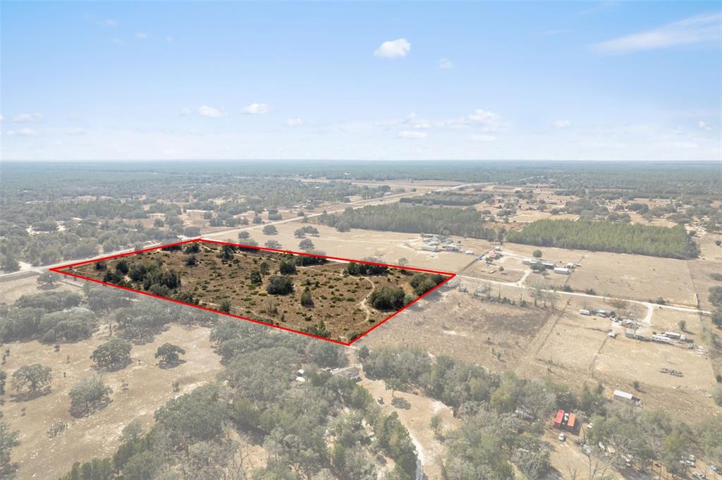 An aerial view shows a rectangular plot of land outlined in red in a rural area — 6725 S RAINBOW POINT, HOMOSASSA, FL