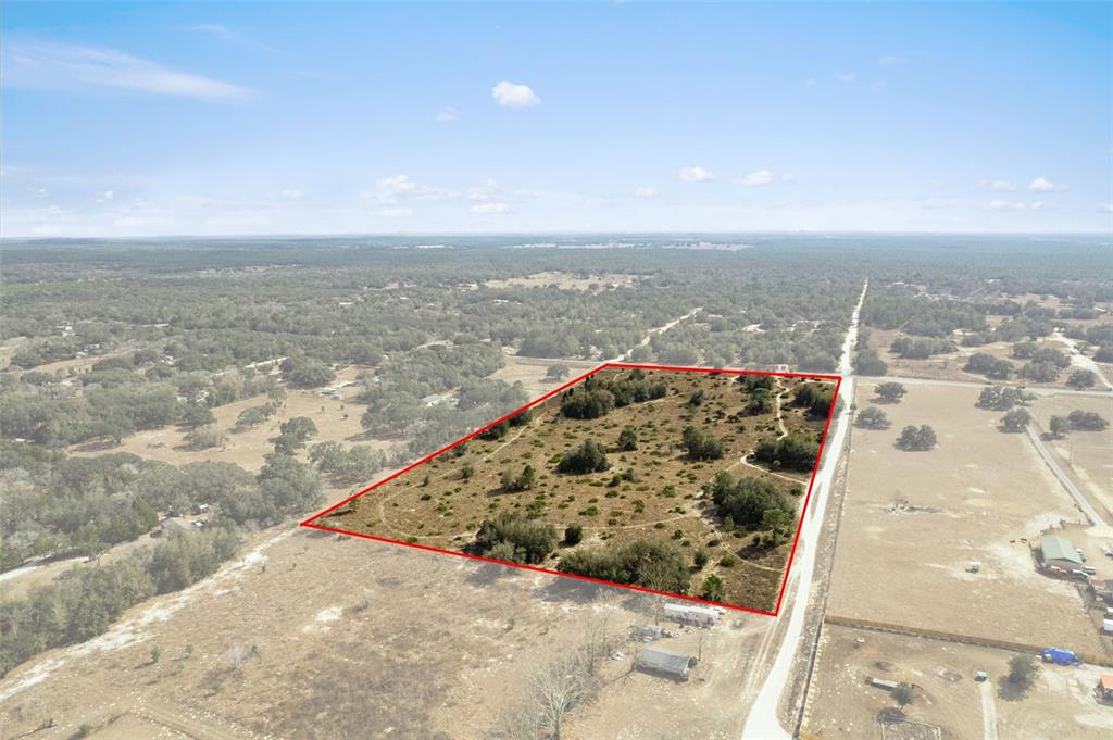 An aerial view shows a rectangular plot of land outlined in red near a road — 6725 S RAINBOW POINT, HOMOSASSA, FL