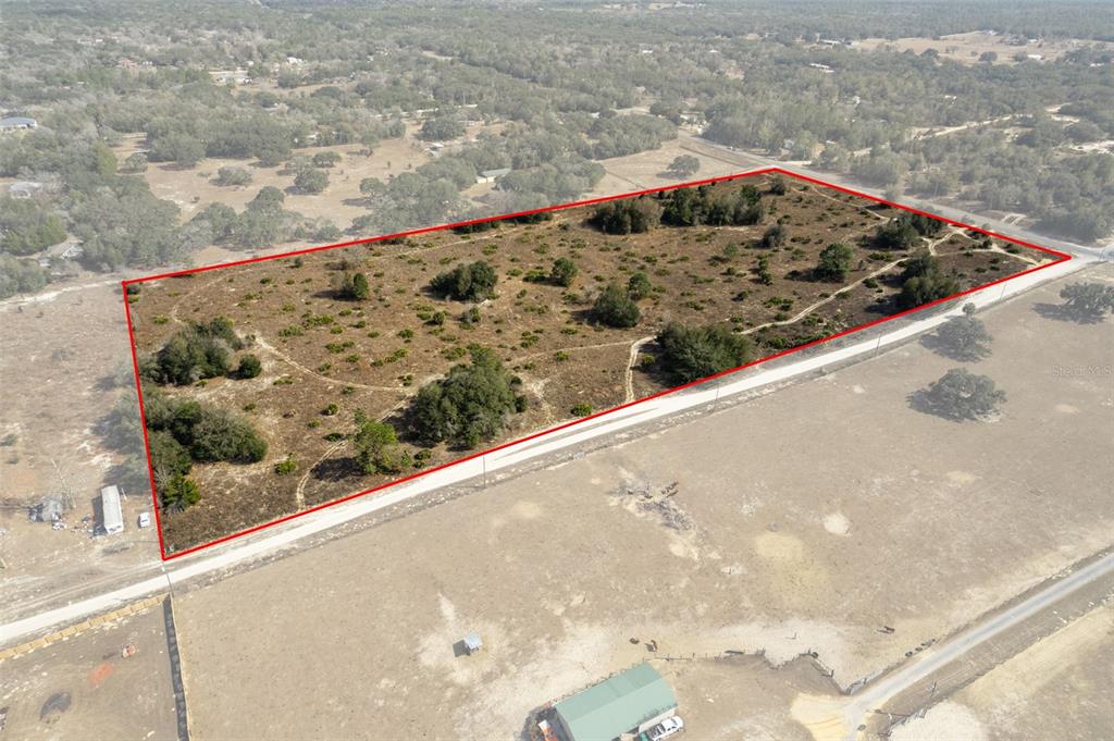 An aerial view shows a rectangular plot of land outlined in red near a road — 6725 S RAINBOW POINT, HOMOSASSA, FL