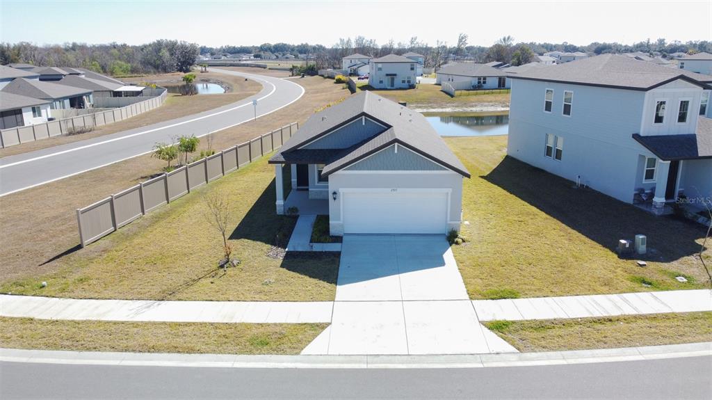 An aerial view shows a single-story suburban house with a two-car garage and driveway — 2707 VIRGINIA PINE DRIVE, BARTOW, FL