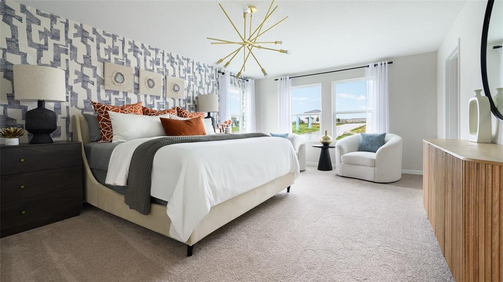 A bedroom features a patterned accent wall, a gold sputnik chandelier, and a king-sized bed — 36683 THORNHEDGE DRIVE, ZEPHYRHILLS, FL