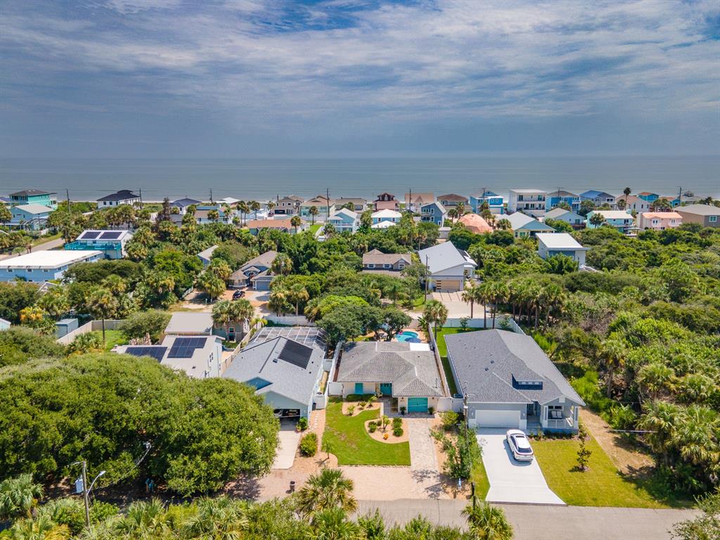An aerial view of a coastal neighborhood featuring several houses with driveways and lush vegetation — 2617 S DAYTONA AVENUE, FLAGLER BEACH, FL