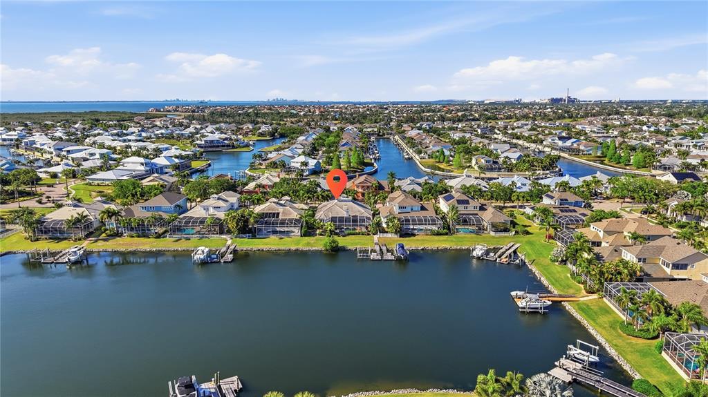 An aerial view shows waterfront houses with private docks along a canal in a neighborhood — 510 MIRABAY BOULEVARD, APOLLO BEACH, FL