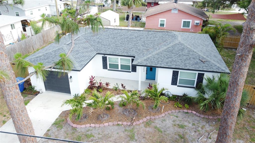 An aerial view of a white single-story house with a gray roof and blue door — 3054 ADRIAN AVENUE, LARGO, FL