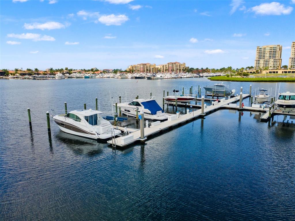 A marina features several docked motorboats and yachts under a bright blue sky — 1105 3RD STREET E, PALMETTO, FL