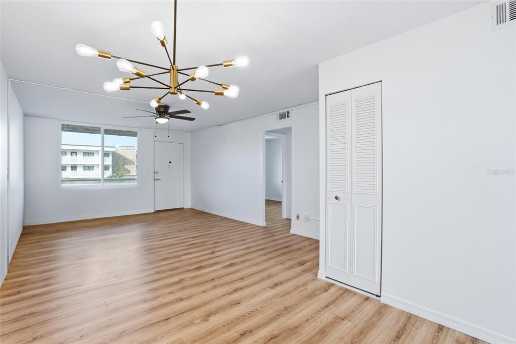 A multi-story apartment building features a covered parking area with several parked vehicles — 5095 BAY STREET NE UNIT 210, ST PETERSBURG, FL