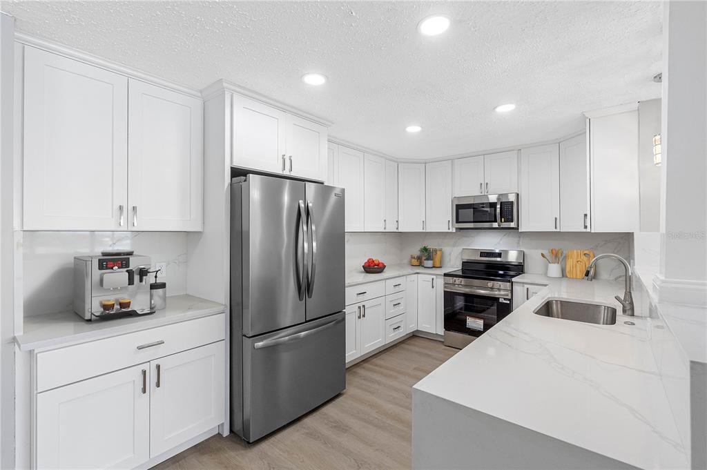 This is a floor plan showing a two-bedroom apartment with an office and two bathrooms — 100 BLUFF VIEW DRIVE UNIT 404C, BELLEAIR BLUFFS, FL