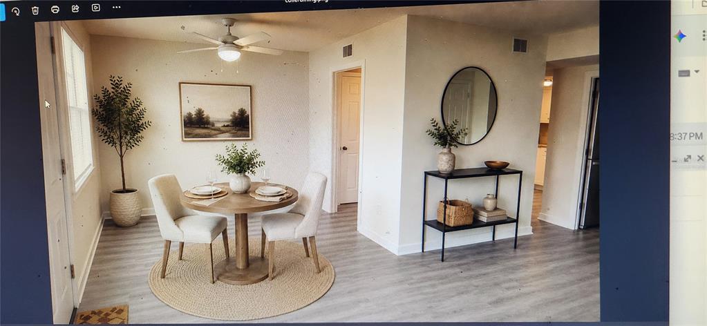 A dining area features a round wooden table, two chairs, and a console table — 8100 DR MARTIN LUTHER KING JR STREET N UNIT 105, ST PETERSBURG, FL