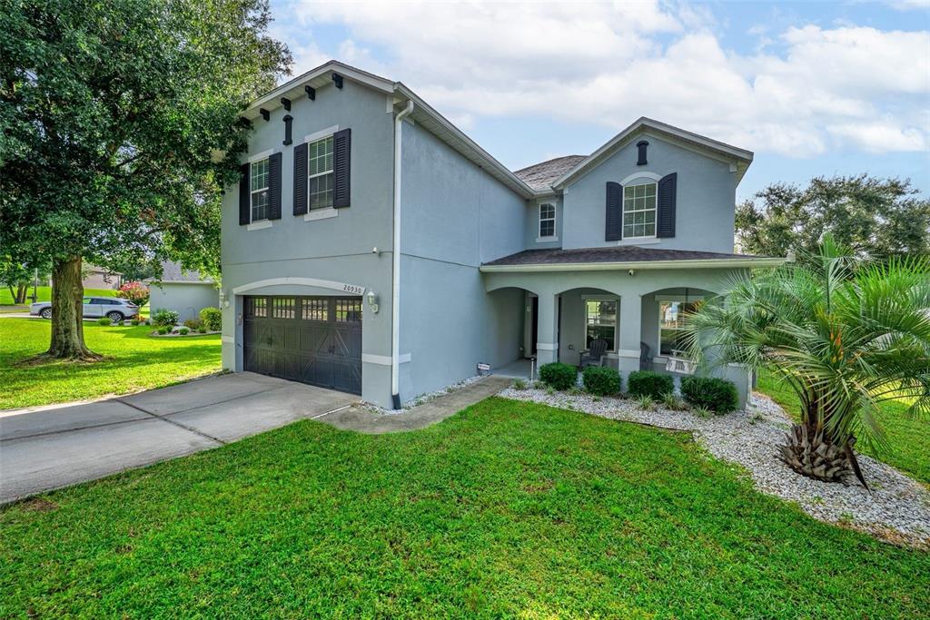 A two-story light blue house with a garage and a covered front porch — 20930 SULLIVAN RANCH BOULEVARD, MOUNT DORA, FL