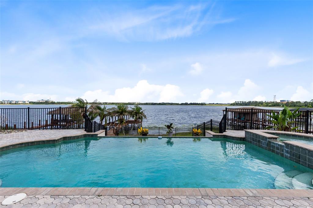 A single-story house with a gray exterior, a large tree, and a paved driveway — 10273 COVE LAKE DRIVE, ORLANDO, FL