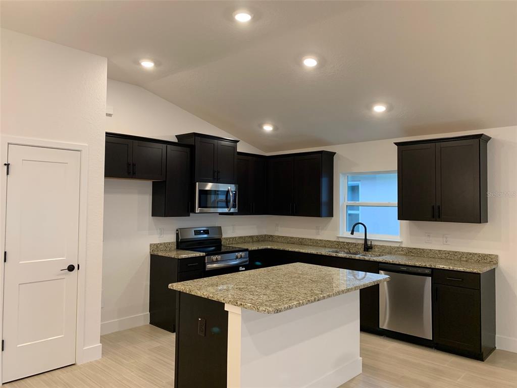 This is a floor plan for a three-bedroom house with a two-car garage and patio — 11619 GRACE ROAD, WEEKI WACHEE, FL