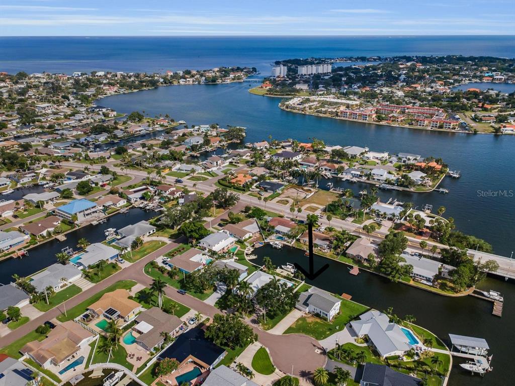 An aerial view shows a waterfront house with a pool located on a canal — 1310 41ST AVENUE NE, ST PETERSBURG, FL