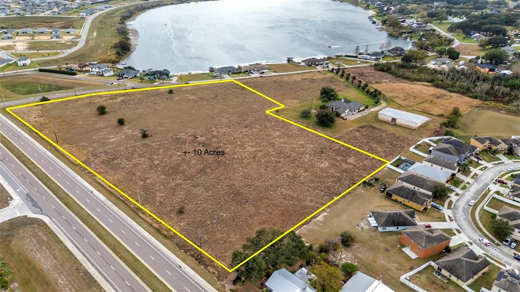 An aerial view shows a large, vacant, rectangular plot of land outlined in yellow — 0 OLD BERKLEY RD, AUBURNDALE, FL