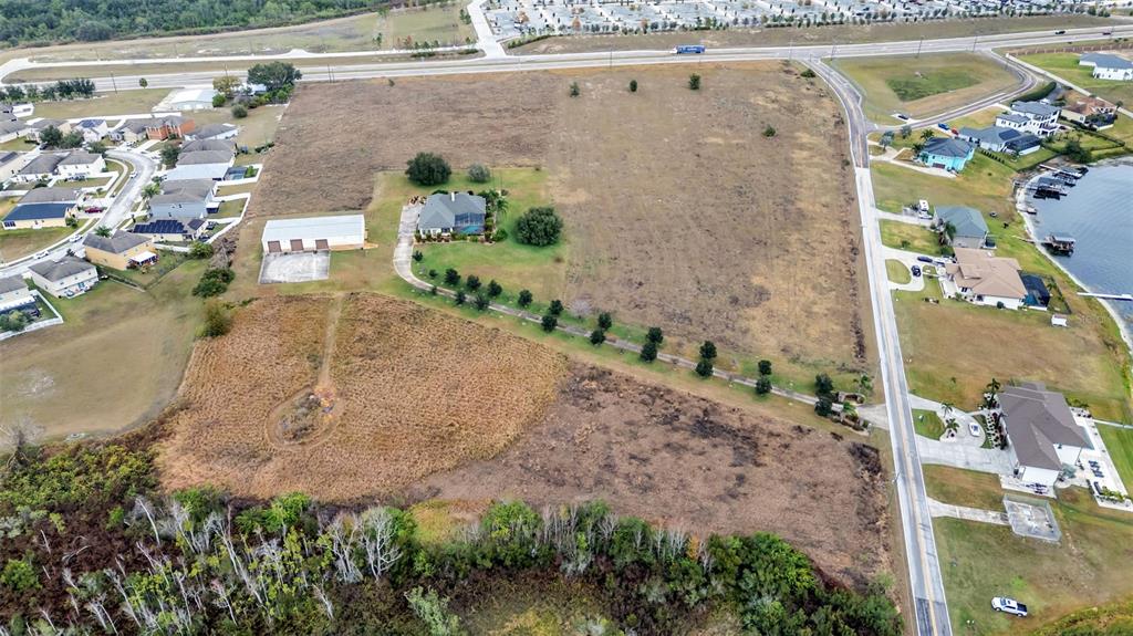 An aerial view shows a large residential lot with a house, outbuilding, and surrounding fields — 0 OLD BERKLEY RD, AUBURNDALE, FL